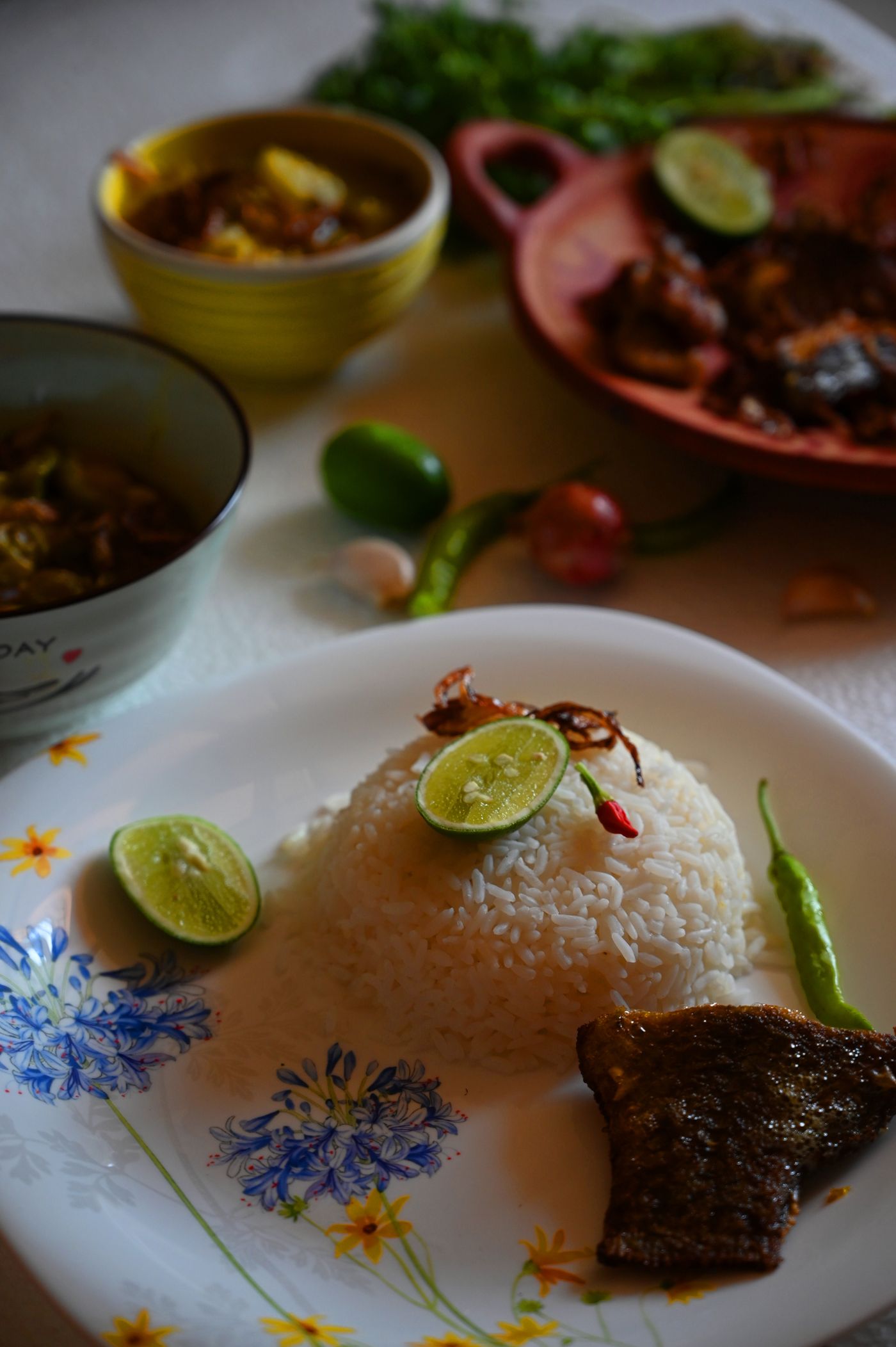 Fish curry served with rice and fresh accompaniments